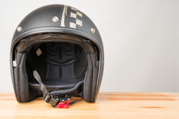 Motorcycle protective gear - helmet on a wooden background.