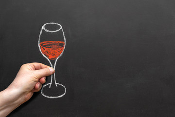 drawing of a glass of wine, made with chalk on a blackboard, with copy space