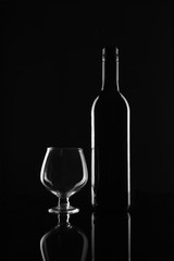 Red Wine Bottle and Glass on Black Background