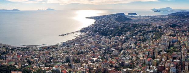 Aerial view at the dusk of the waterfront of Naples, the Chiaia and Mergellina neighborhoods, from the Vomero hill. There are on background Capri and Nisida Island, Posillipo and Fuorigrotta districts - obrazy, fototapety, plakaty