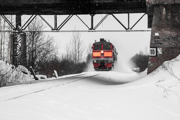 diesel locomotive quickly travels on snow-covered railways