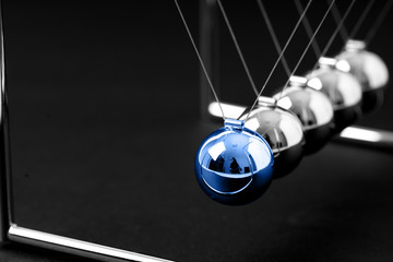 Newtons Cradle balancing balls, business concept in studio