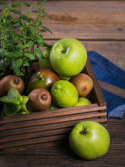 Set of green fruits for healthy diet and detox: apple, lime, kiwi, mango, carambola and mint.