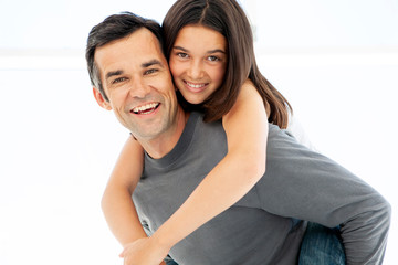 Teenage girl playing with middle aged father - portrait