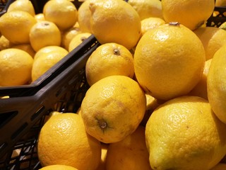 Boxes with fresh lemons in the supermarket. 