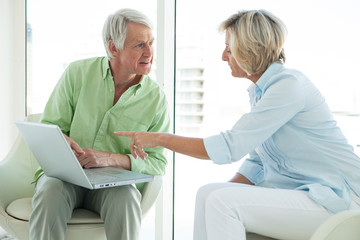 Obraz premium Senior active couple using laptop together at home