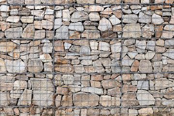 Keermuur gabion manden, Gabion muur gekooide stenen getextureerde achtergrond