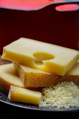 Assortment of Swiss cheeses Emmental or Emmentaler medium-hard cheese with round holes, Gruyere, appenzeller and raclette used for traditional cheese fondue and gratin