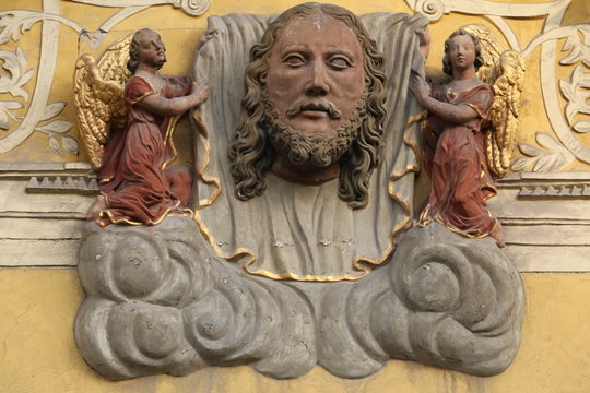 Stone statue. Face sculpture of a bearded man. A sculpture located on the wall of a building, a tenement house in the city. Świdnica, Schweidnitz, Svidnica, Lower Silesia, Polska, Polen, Poland.