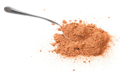 spoon in pile of cocoa powder isolated