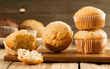 Vanilla cupcake, homemade pastry on wooden background, close-up