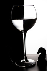 Glass of water with overlap in the form of a chessboard concept