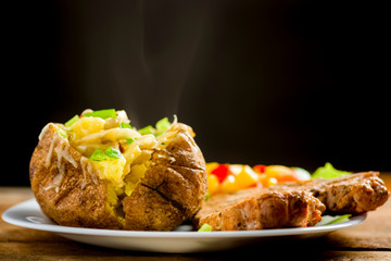 roasted pork chop and potatoes with stuffed skin