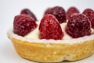 Raspberry birthday cake on a white background, copy space