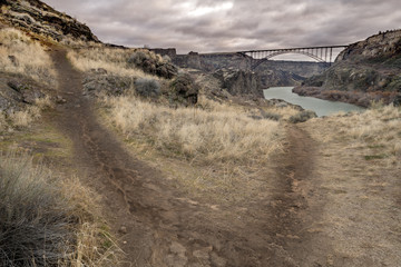 Foot path trails lead through the hills below the famous Prine Bridge in Twin Falls