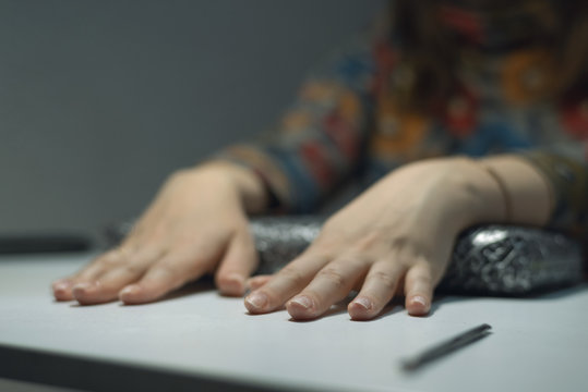 Woman Is Drying Her Fingernails On A Table In A Nail Care Salon.