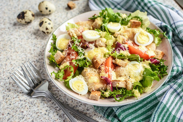 Fresh caesar salad with chicken breast, lettuce and tomatoes. Delicious spring salad