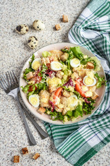 Fresh caesar salad with chicken breast, lettuce and tomatoes. Delicious spring salad