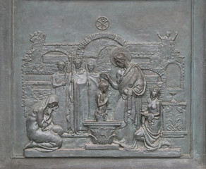 Bronze door with the image of the life of St. Peter: St Peter Baptizing in the Catacombs, basilica of Saint Paul Outside the Walls, Rome, Italy 