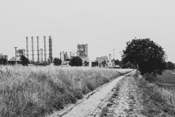 Naklejka na ściany i meble Black and white photo of industrial suburban landscape