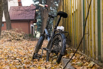 Bicycle locked to the fence during autumn. Slovakia