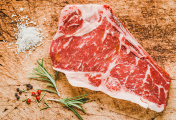 Raw angus meat steak on wooden board copy space.