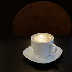 concept of a coffee Cup standing on a dark table