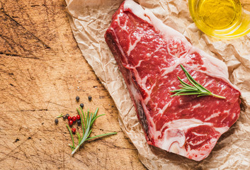 Raw meat steak on wooden board copy space.