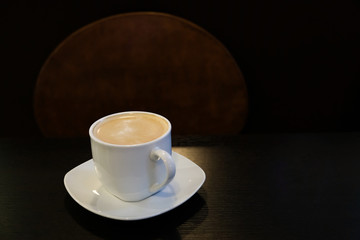 Black coffee on a dark table. Minimalism