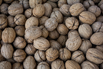 Dry Fruit walnuts are Laying in a basket making background