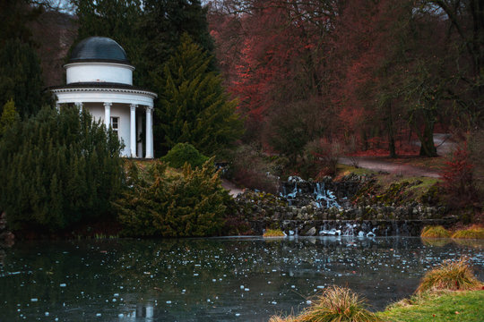 Medieval stone gazebo on the shores of a frozen lake in a park near Casel. Germany