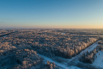 Aerial view of a beautiful sunset in the winter forest. 