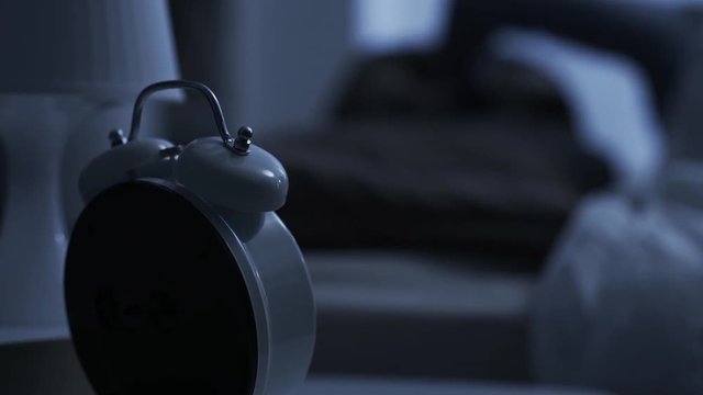 Loud old fashioned alarm clock ringing early in the morning