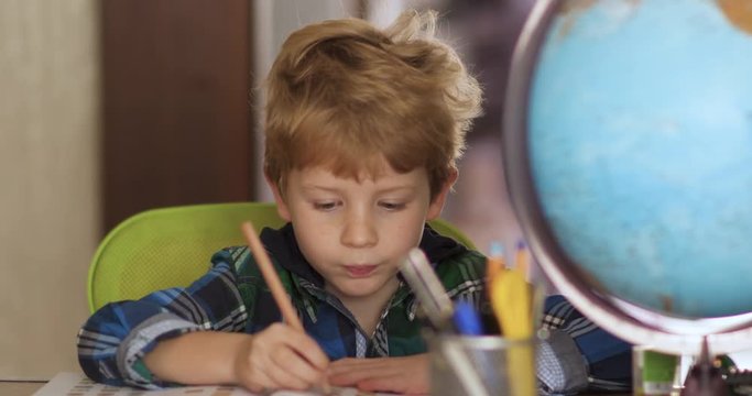 Young Blond First Graders Do Homework At Home.