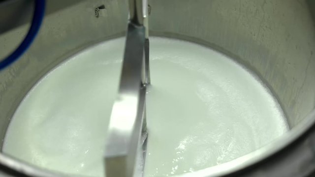 Sour cream and yoghurt production. Pasteurization of milk in metal container. Process of making dairy products.