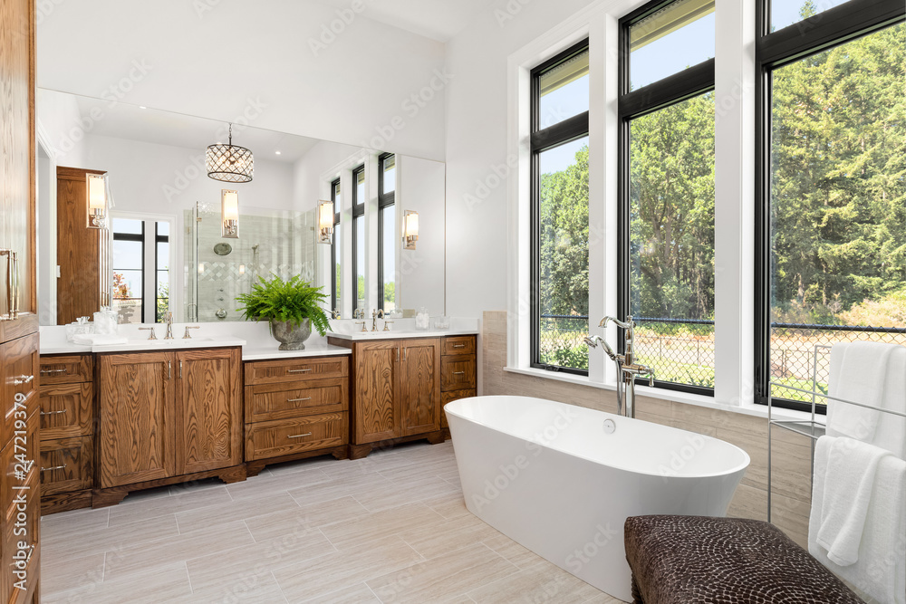 Wall mural beautiful bathroom in new luxury home, with double vanity, bathtub, and shower visible in mirror ref