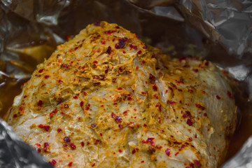 Closeup of baked turkey breast with spices in the foil