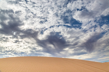 Fototapeta na wymiar Dramatic clouds above the Imperial Sand Dunes in California