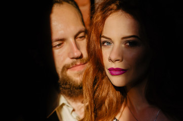 Fototapeta premium Fun and a lovely family portrait of a young cheerful joyful couple. Smile and feels happy. Outdoor shot of young beard male with his ginger girlfriend. Love story. Valentine Day