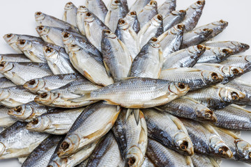 Big heap of dried salted sea roach on a white background