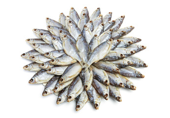 Naklejka na ściany i meble Large heap of dried salted sea roach laid out in the form of a circle on a white background
