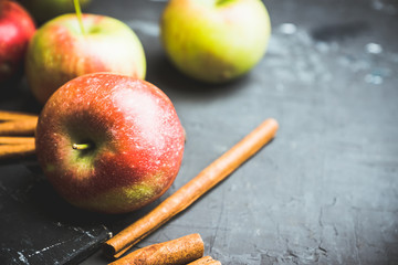 Apples with cinnamon on rustic wooden background. Selective focus. 