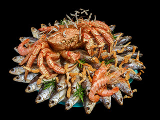 Big hairy boiled crab sits on a heap of dried salted fish on a gift bouquet on the black background, side view