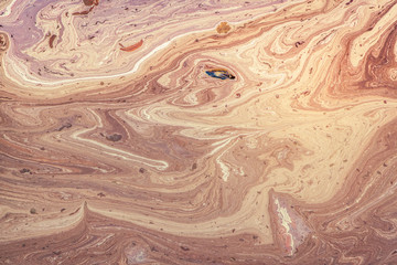 Pollution of water surface with oil products. The surface of the sea is brown