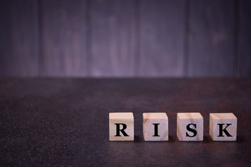 Word risk on wooden cubes, light wooden cubes signs