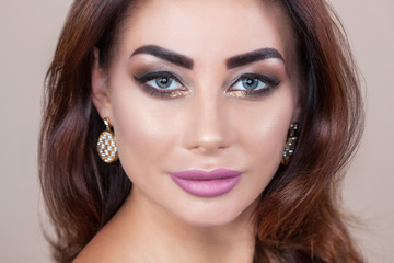 Obraz premium Portrait of attractive young woman with beautiful make-up and manicure.