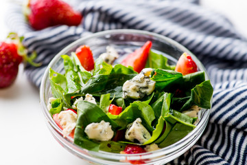 bowl of vegan  salad with strawberries and blue cheese