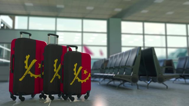 Travel suitcases featuring flag of Angola. Angolan tourism conceptual animation