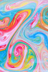 Fluid art with different colors. Multicolored background from paints on liquid. Bright pattern on liquid. Colored paint stains in pop art style