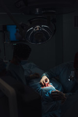 Obraz premium Surgeon and his assistant performing cosmetic surgery on nose